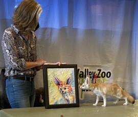 a Fennic fox examining his painted quilted portrait